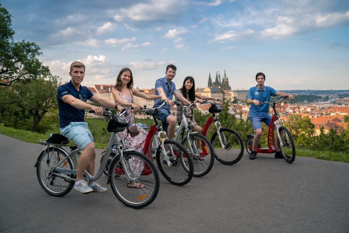 a group of people riding on the back of a bicycle