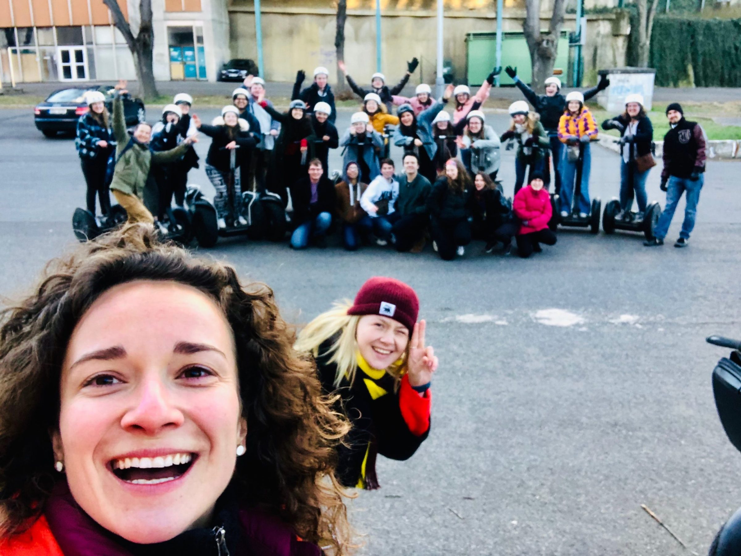 a group of people standing in a parking lot